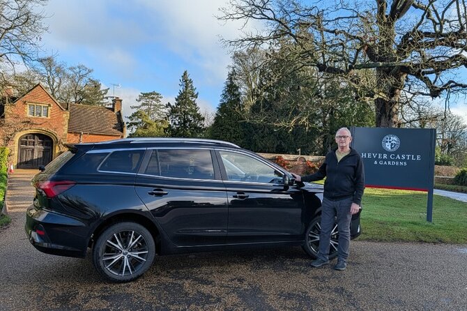 Paul standing beside his car at the Hever Castle & Gardens sign