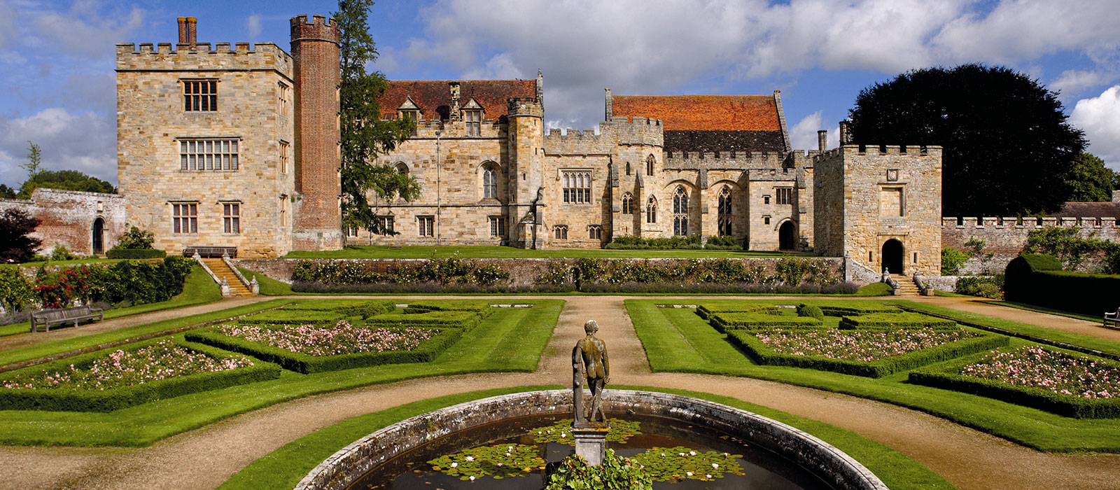 Penshurst Place seen across its formal gardens and fountain pond